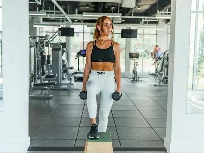 Woman holding a pair of dumbbells