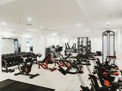 Exercise bikes and weight stations in a bright gym